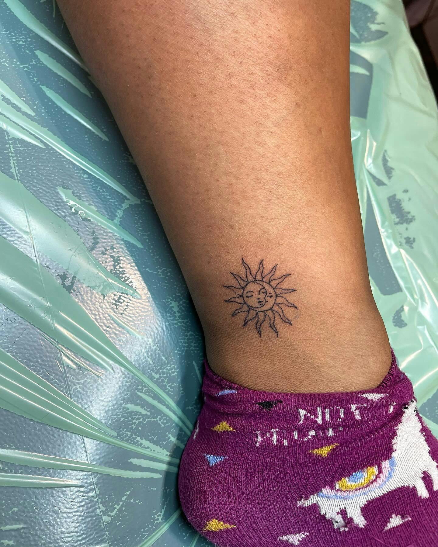 Sun and moon ankle tattoo, celestial sun and moon design for ankle.