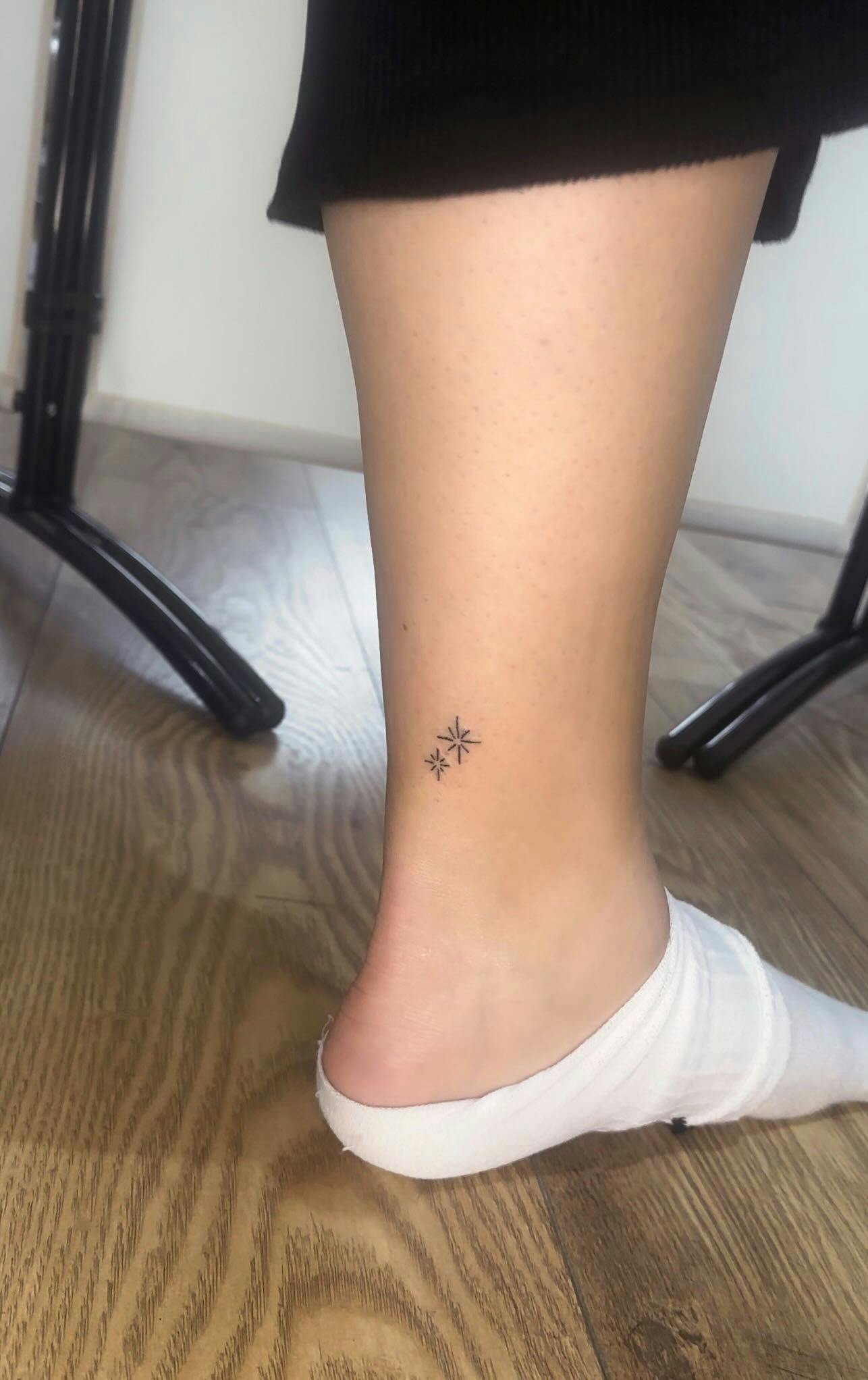 Star ankle tattoos on feet, minimalist star design for women.