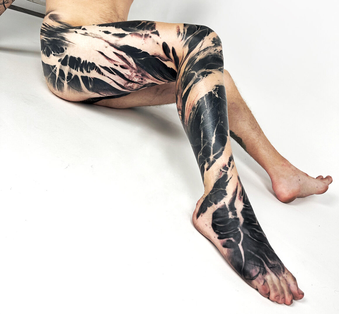 Collaborative abstract tattoo by Natalie Nox and Benjamin Laukis, highlighting shared artistic vision