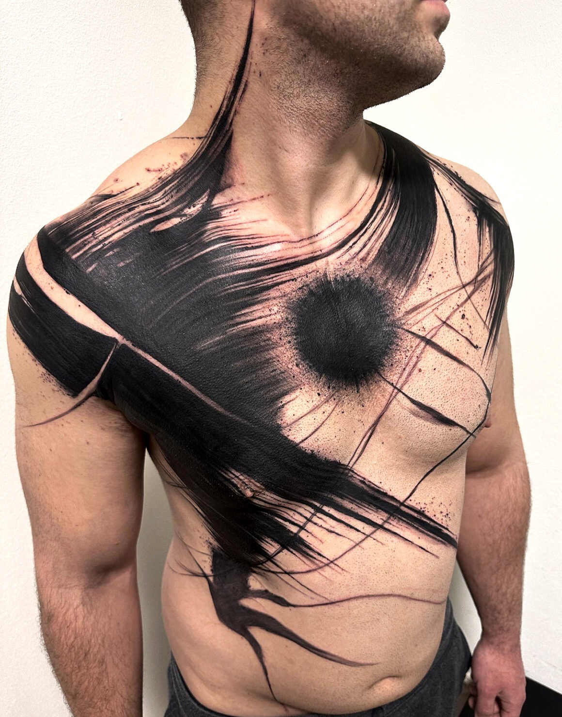 Black and grey abstract tattoo by Natalie Nox, highlighting contrast and form