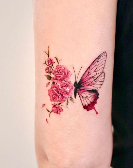 Pink rose and butterfly tattoo on forearm, blending floral and nature elements.