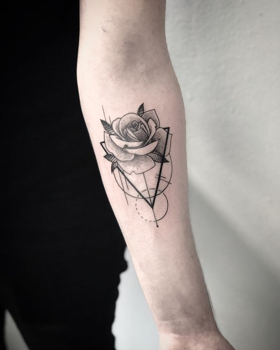 Geometric rose tattoo on forearm with intricate line patterns and shading.