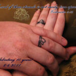 Realistic black ink cord of three strands tattoo on a woman's wrist.