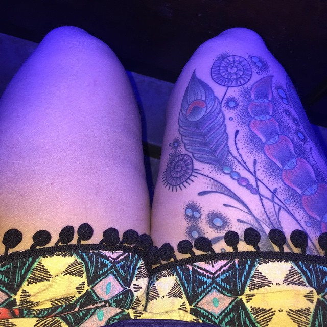 Heavily tattooed man in a suit.