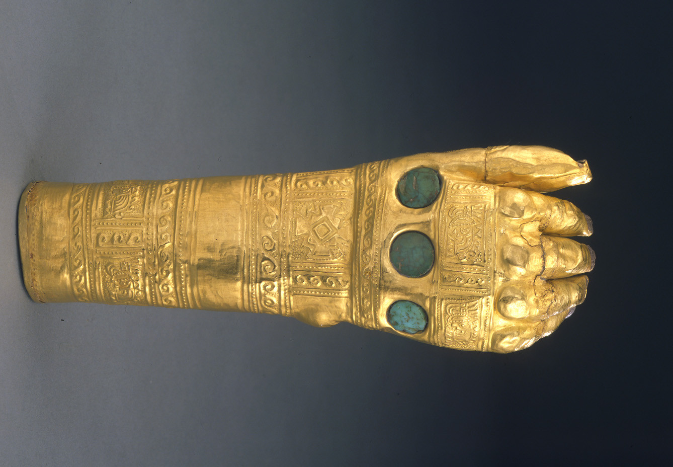 Hammered gold hand with intricate tattoo motifs from the Lambayeque (Sicán) culture, 800-1370 A.D.