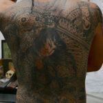 Young Yakuza member shows off his back piece