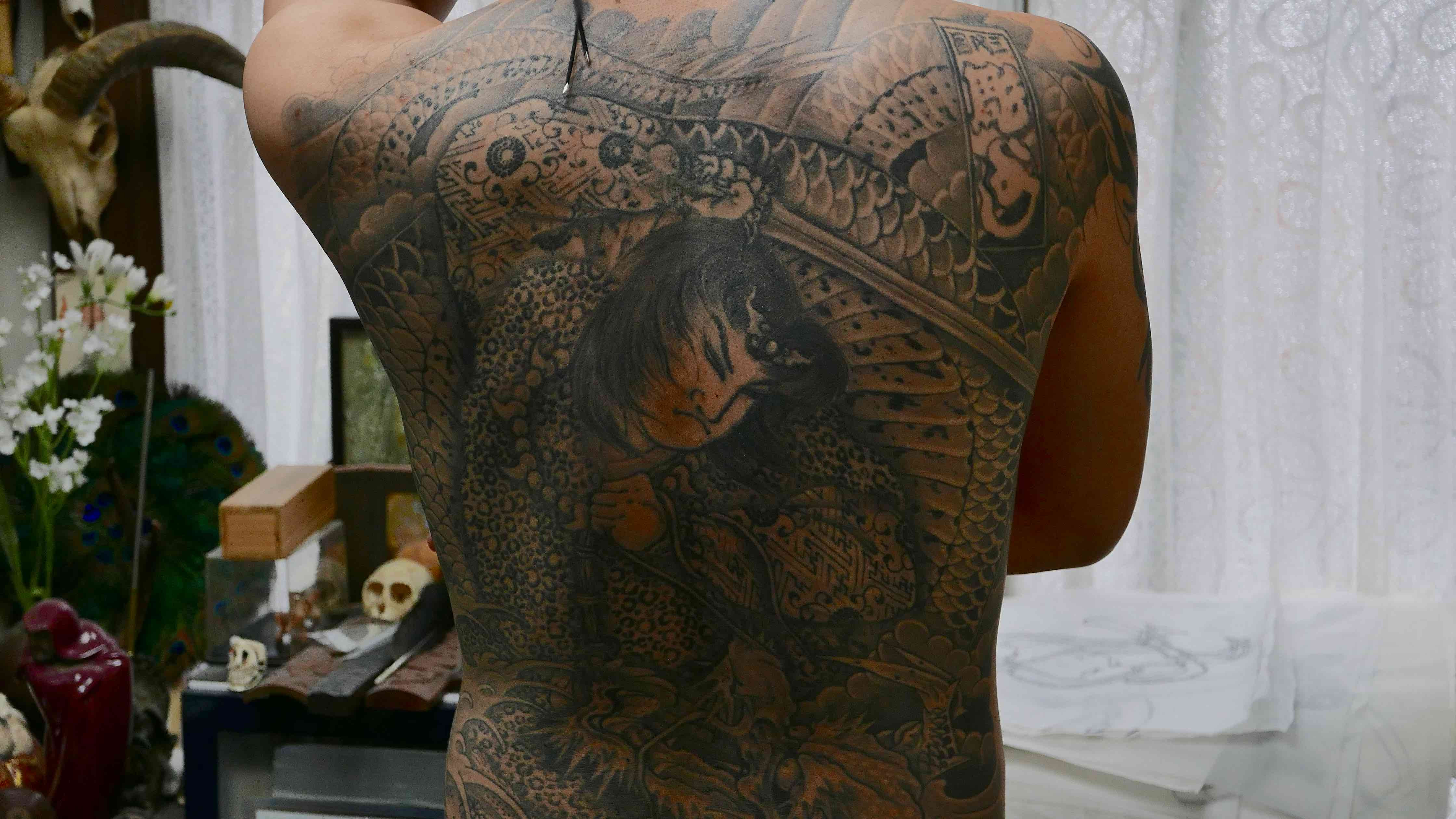 Young Yakuza member shows off his back piece