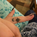 Hand-poked tattoo on fingers
