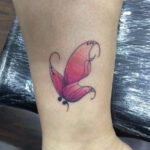 tattoo on ankle of butterfly and semicolon