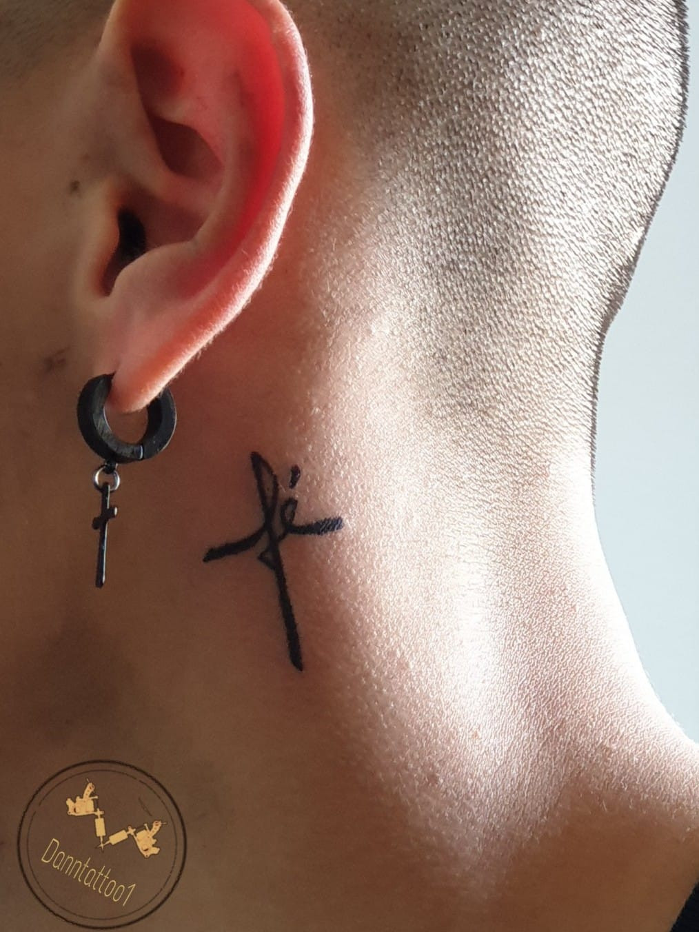 A collection of various minimalist cross tattoos placed on fingers.