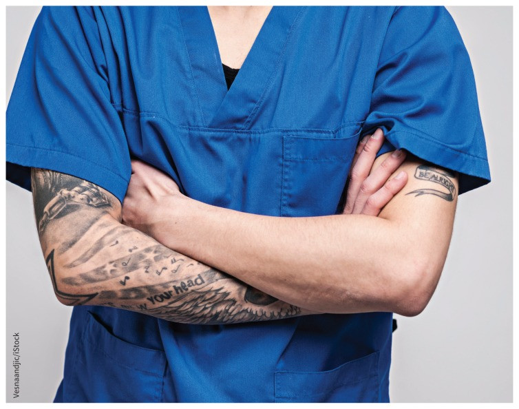 Doctor with tattoo on arm