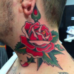 A detailed neck tattoo featuring intricate floral patterns