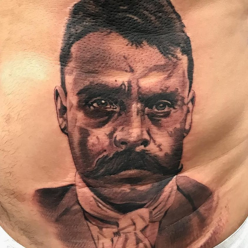 Tattoo by El Whyner portraying Emiliano Zapata, a revolutionary figure, showcasing the historical and political depth in Chicano tattoos.