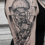 A minimalist jellyfish tattoo design on a wrist, symbolizing adaptability and inner peace.