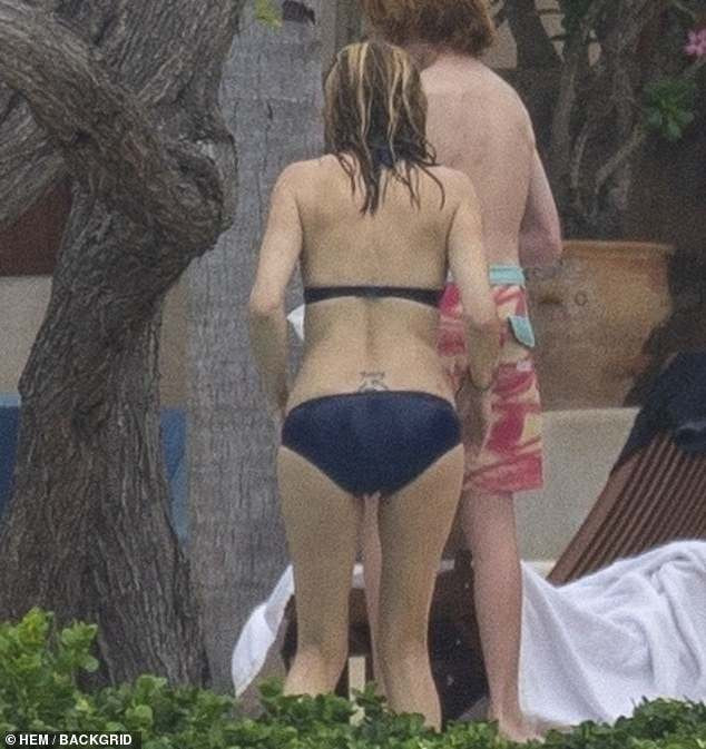 Julia Roberts' lower back tattoo displaying her children's names and husband's initials.