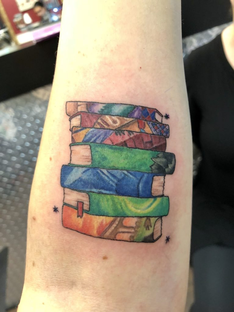 Vibrant colored book tattoo