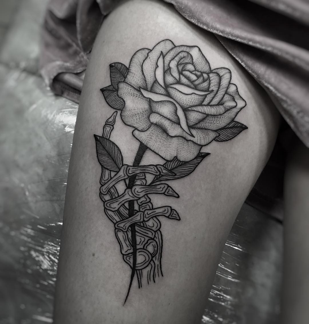 Woman applying sunscreen on her arm tattoo