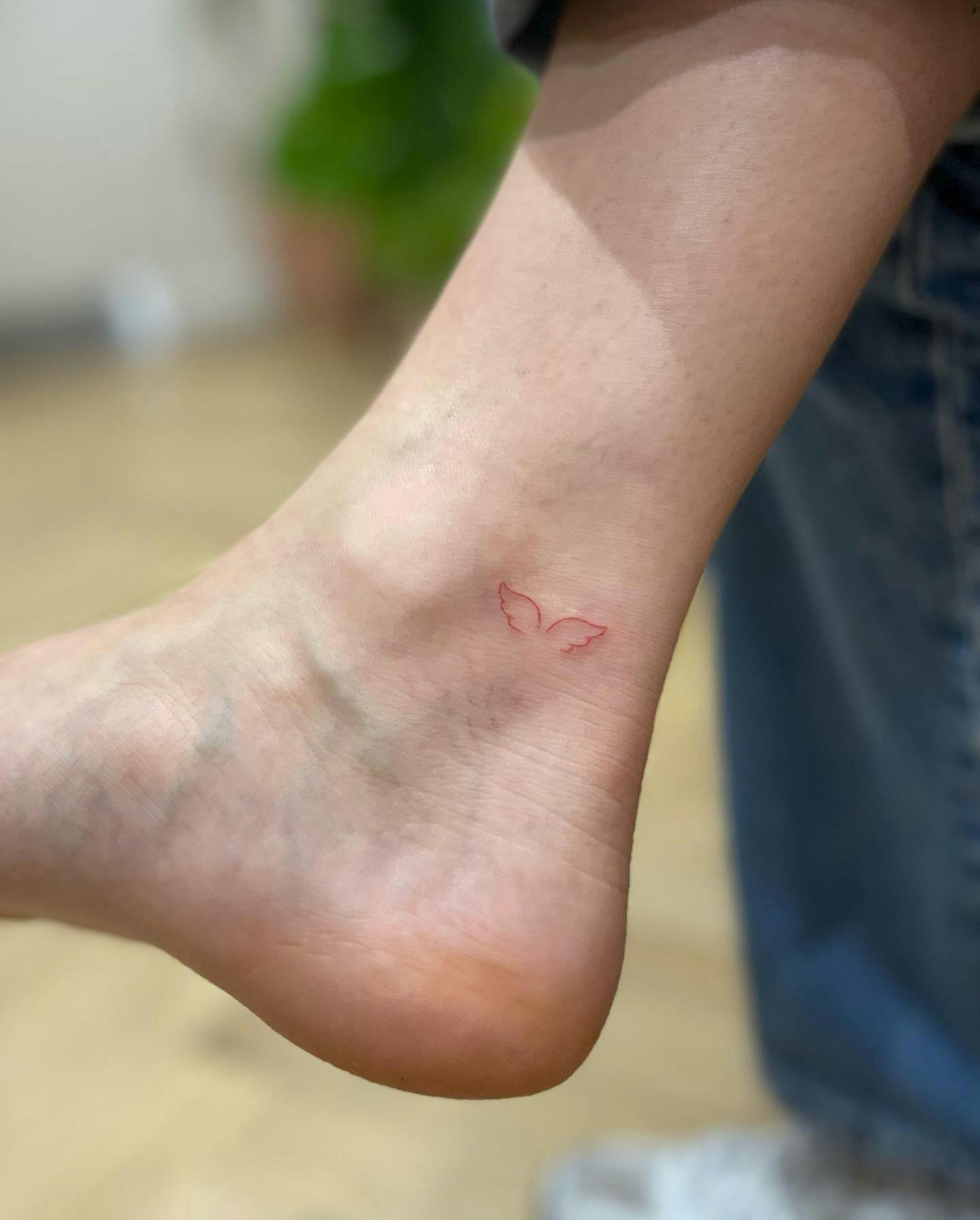 Angel wings ankle tattoo