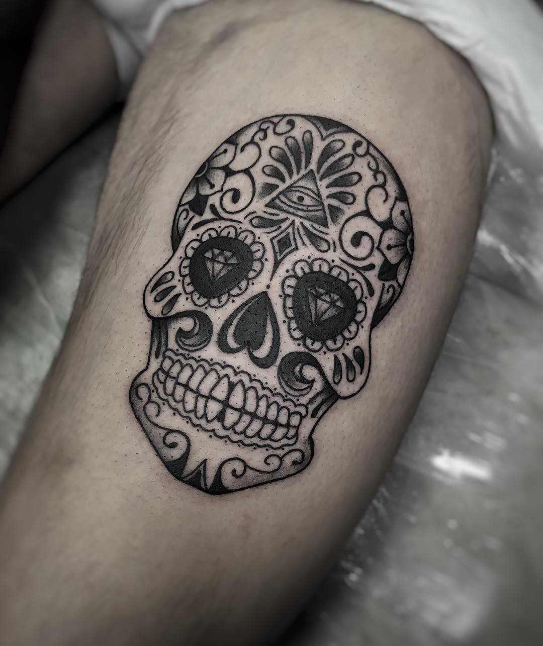 Tattoo artist applying aftercare cream on a freshly inked tattoo