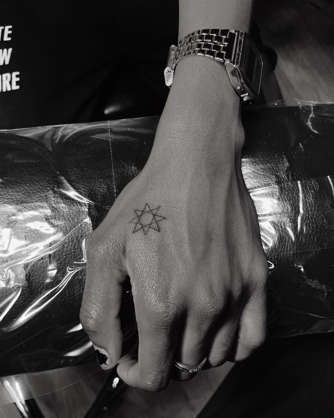 A small star tattoo design on a woman's hand, perfect for those seeking a simple yet chic design.