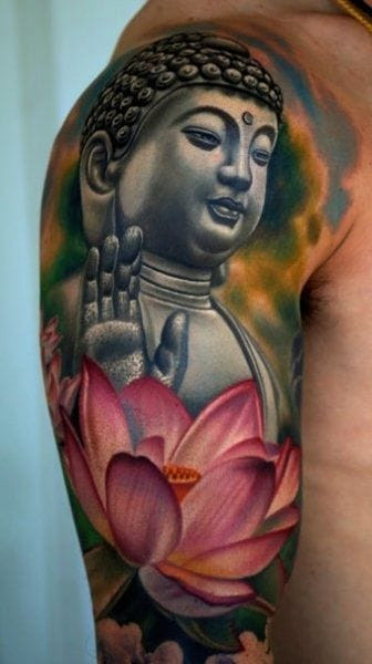A soft color Buddha tattoo on an arm