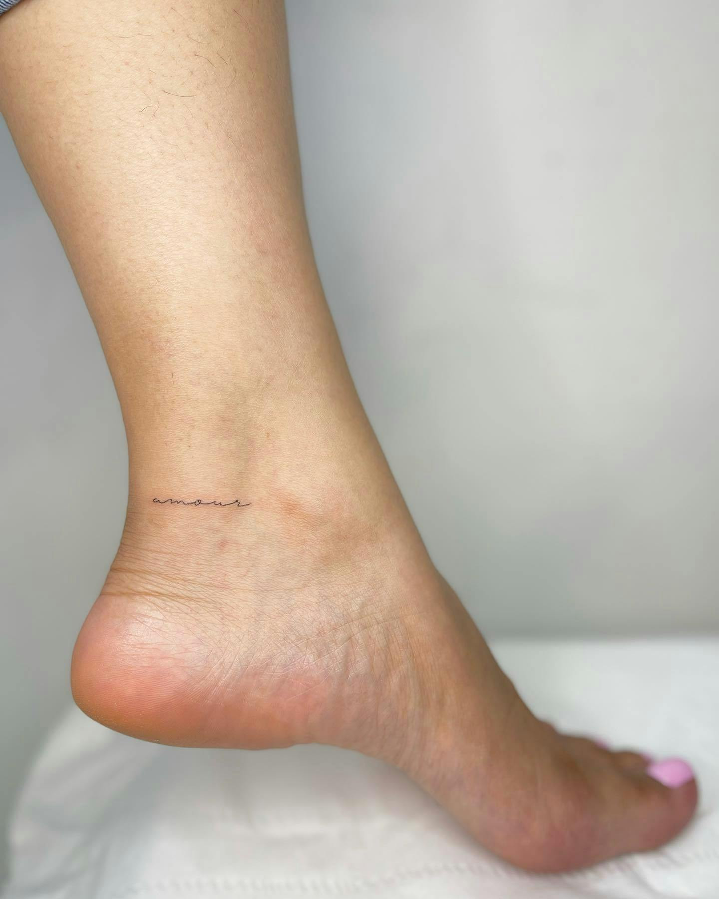 Small script ankle tattoo