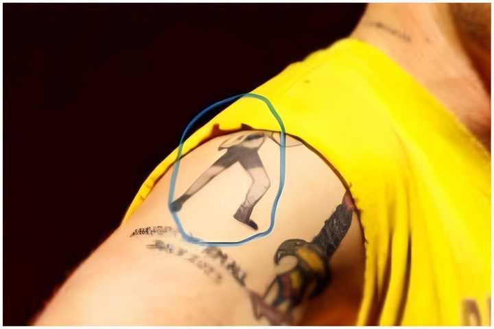 Zach Bryan showing off his boxing man tattoo.