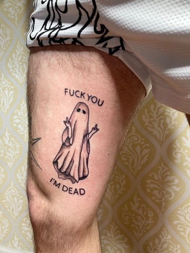 Man's inner thigh ghost tattoo adding an element of surprise and humor