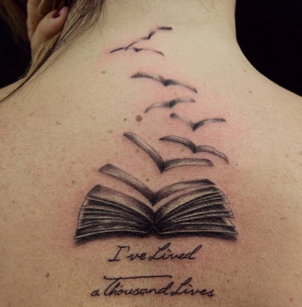 Book pages turning into birds tattoo