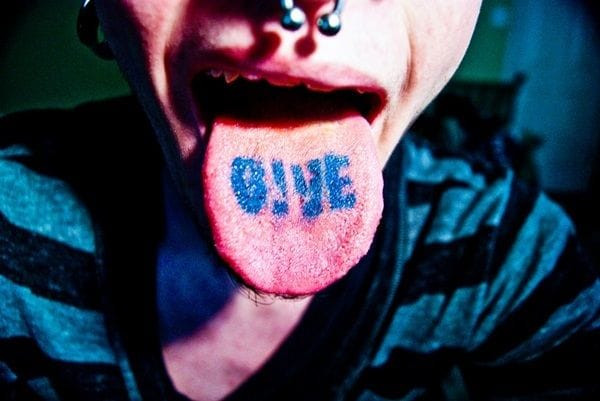 Preparing for a tongue tattoo by brushing and using mouthwash