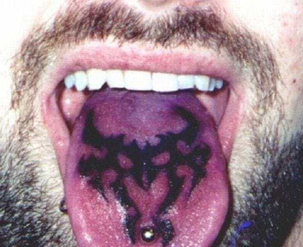Black and white tongue tattoo featuring a minimalist design