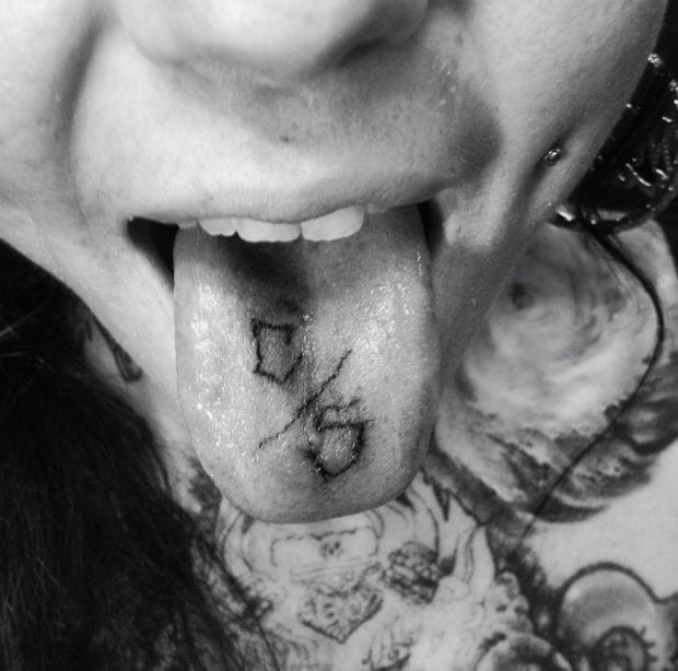 A person rinsing their mouth with mouthwash, emphasizing tongue tattoo aftercare