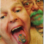 Close-up of a tongue tattoo with a simple black design