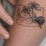 Small illustrative tattoo of a minimalistic flower on a woman's arm, showcasing simplicity and elegance in tattoo art.