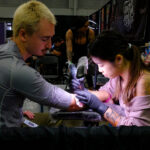 Ella Emhoff displaying her tattoos, showcasing modern body art
