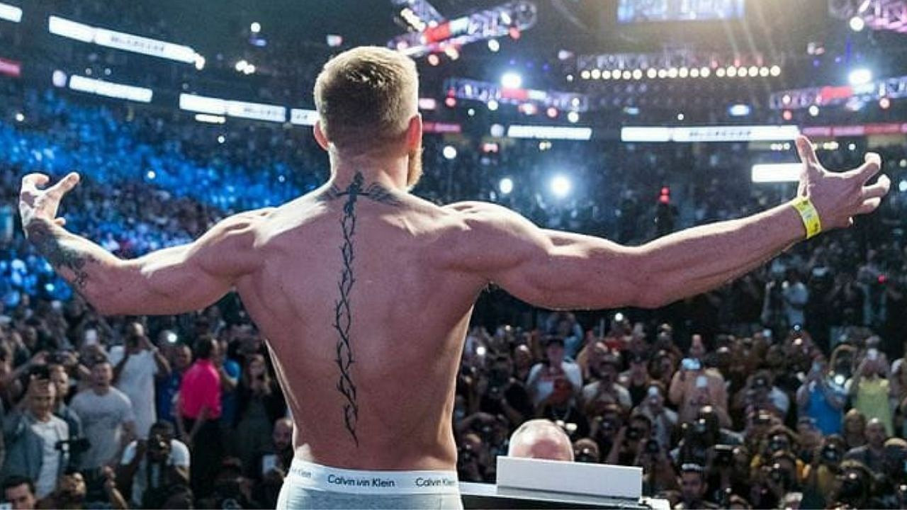 Conor McGregor back piece featuring a crucifix and helix pattern, symbolizing faith and resilience