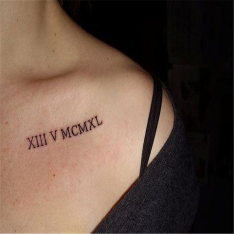 Roman numeral collarbone tattoo following the natural curve of the bone