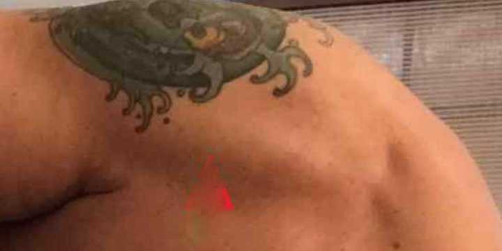 Titus Welliver showcasing his koi fish tattoo on his shoulder