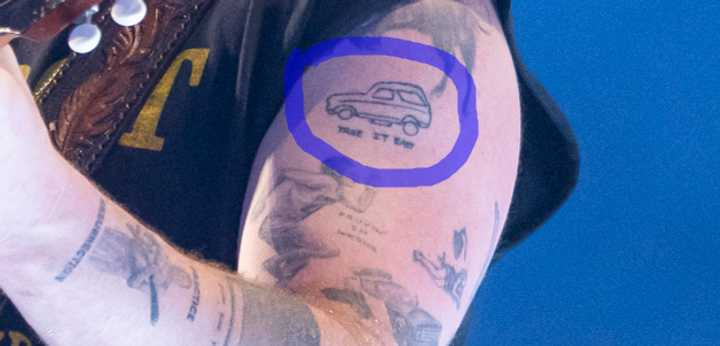 Close up of Zach Bryan's car tattoo on his bicep.
