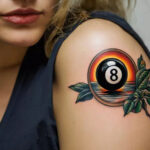 A traditional 8 ball tattoo with beach sunset and foliage, beach scenery that symbolizes overcoming life’s hurdles to find comfort and peace