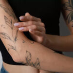 Applying aloe vera to soothe new tattoo