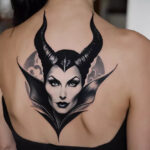 A woman wearing a black-and-white Maleficent tattoo on the back