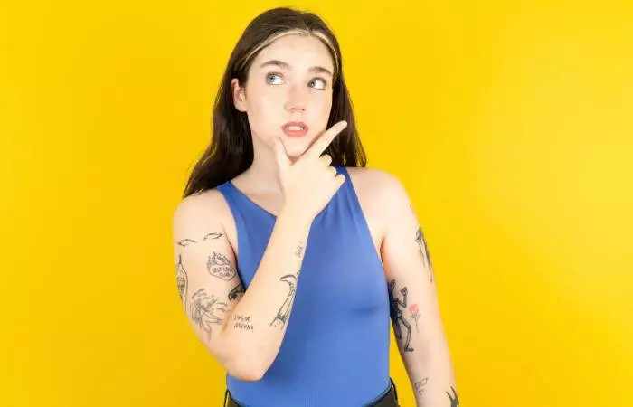 A woman with tattoos wondering