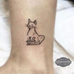 Small book tattoos on fingers and wrists