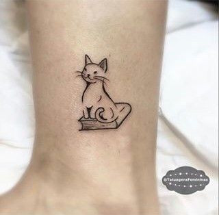 Small book tattoos on fingers and wrists