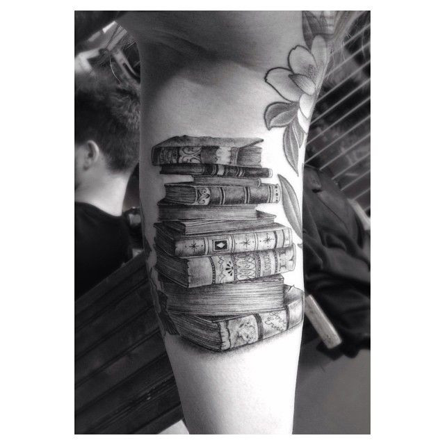 Black book tattoo on arm