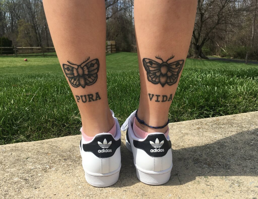 Woman showing off her leg tattoo
