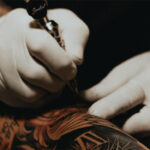 Hold the tattoo machine like you would a normal pen or pencil