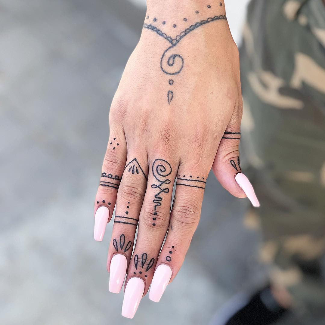 Finger ornaments as a unique hand tattoo, showcasing beautiful designs that resemble rings and jewelry.