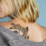 Young blonde woman with fresh back tattoo